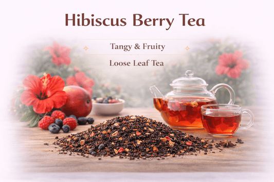Hibiscus Berry Tea with loose leaf tea, hibiscus flowers, and berries on a wooden table.