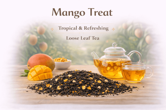 Mango Treat Tea with loose leaf tea and a slice of fresh mango on a light background.